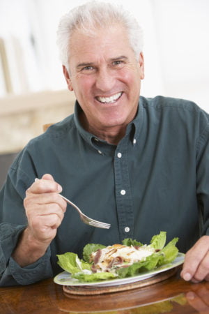 Senior Man Eating A Healthy Meal